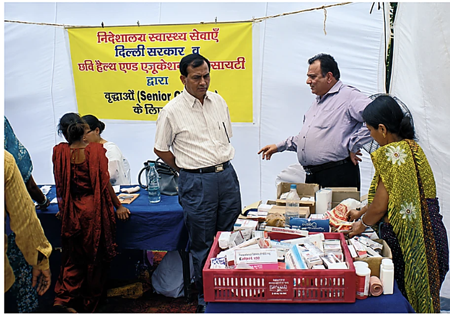 CHES staff and doctors at a medicine distribution table